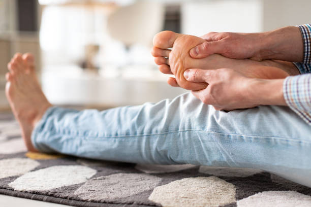 Person massaging their foot to relieve pain after a long day.