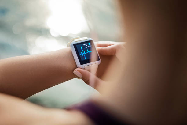 A person checking their smartwatch displaying heart rate data, highlighting the role of fitness apps in staying motivated, working out, and exercising consistently.