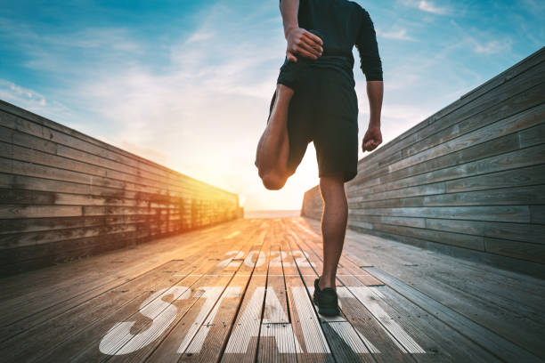 A person stretching their leg as part of a proper warm-up before any workout session.