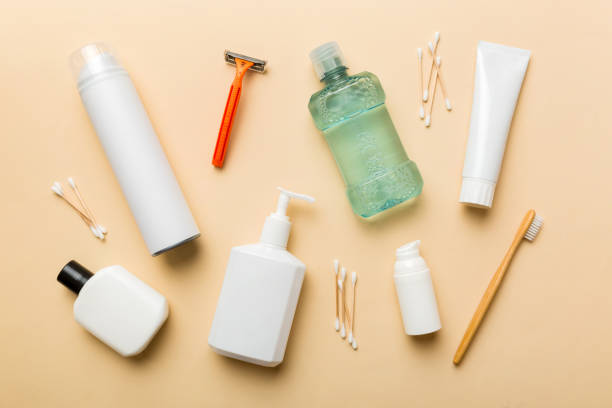 A collection of hygiene essentials, including a razor, mouthwash, lotion, cotton swabs, and a toothbrush, for maintaining daily cleanliness and freshness.