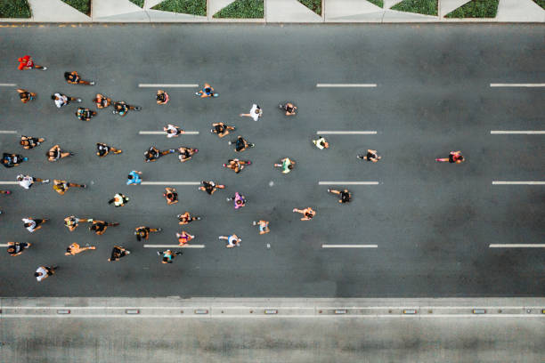 Aerial view of a group of people running on a wide road, emphasizing the importance of incorporating more movement into daily life for better insulin sensitivity and overall health.