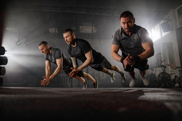 Athletes performing explosive plyometric push-ups as part of performance-based workouts to train like an athlete and enhance strength and endurance.