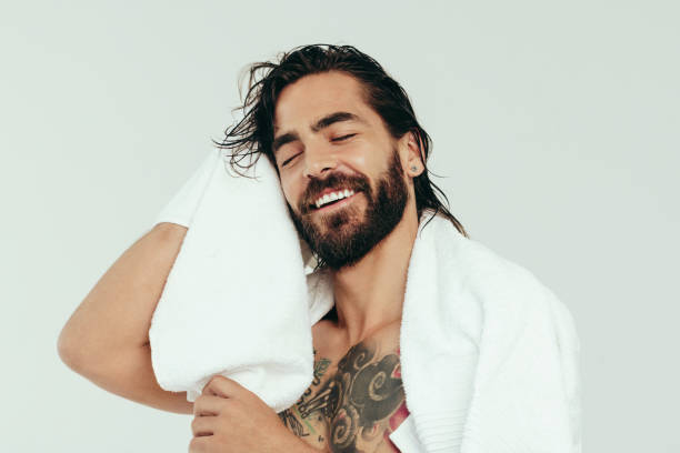 Man drying his hair after applying conditioner – Condition Your Hair.