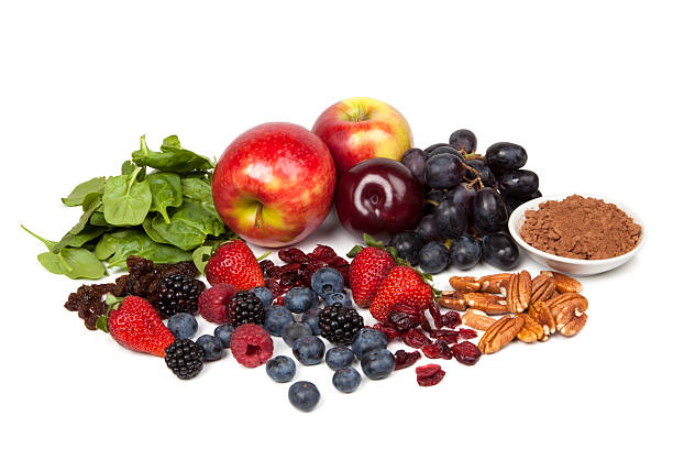 A selection of antioxidant-rich foods, including berries, apples, grapes, spinach, nuts, and cocoa powder, promoting better insulin sensitivity and overall health.