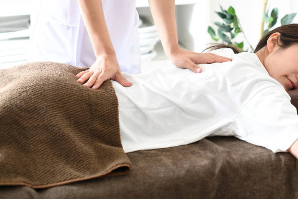 A person receiving Massage Therapy to alleviate Chronic Pain, focusing on relaxation and muscle relief.