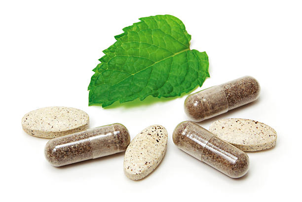 Natural supplements in capsule and tablet form alongside a fresh green leaf, highlighting their potential role in supporting insulin sensitivity and overall wellness.