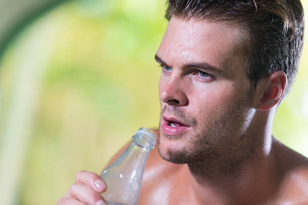 A man drinking water to stay hydrated, an essential habit to improve insulin sensitivity and support overall metabolic health.