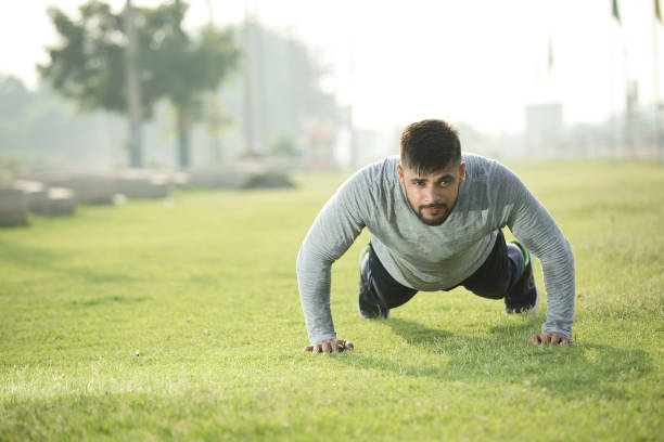 Man performing push-ups outdoors to enhance stamina and endurance.